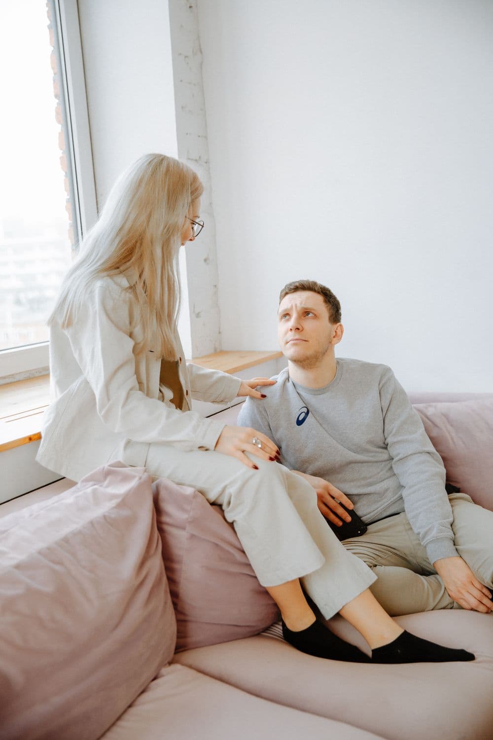 A couple having a quiet conversation on their sofa