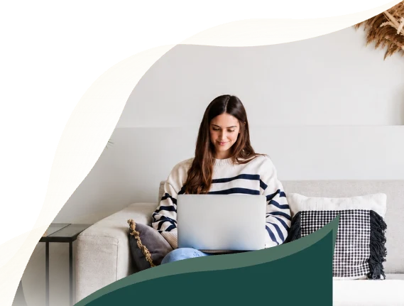 A woman attending an online session from her couch